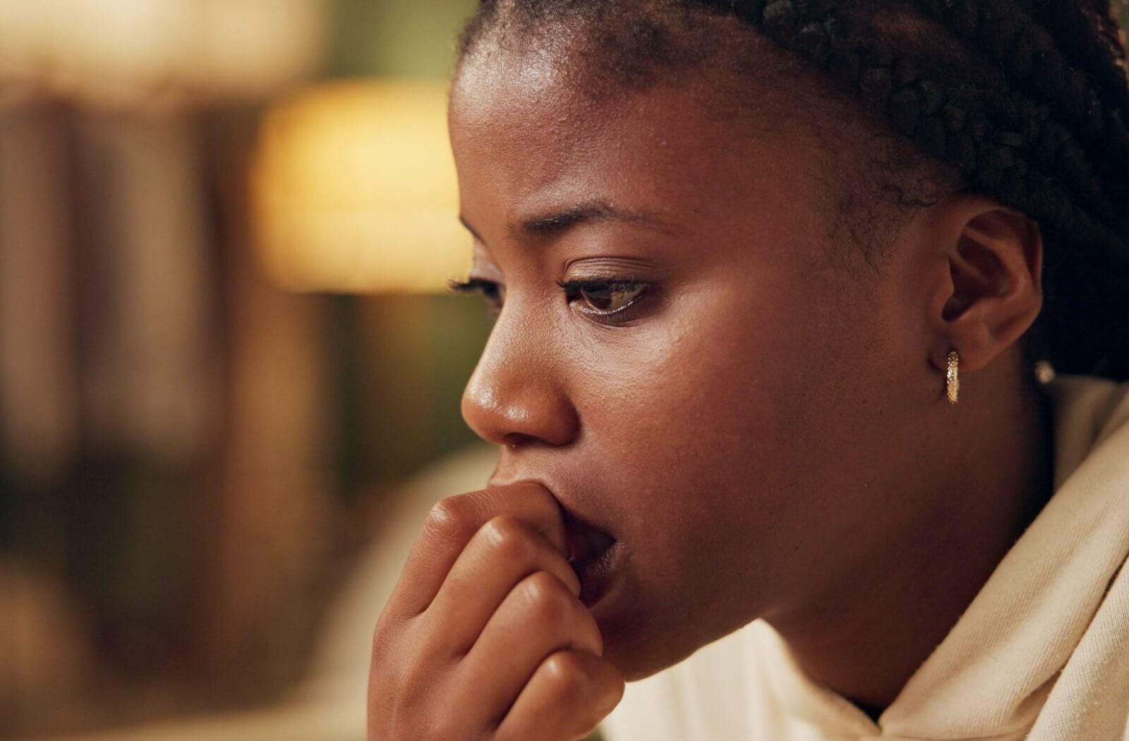 A close-up image of a young person with an anxious look on their face.