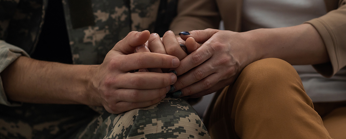  A military couple holding hands.