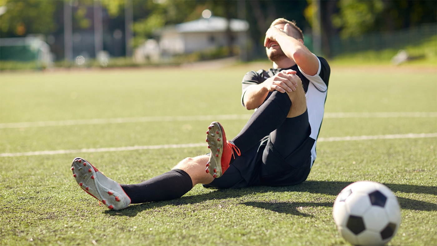 A sport player who has just injured his leg.