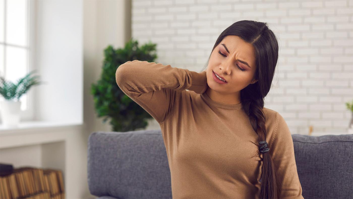 A woman rubbing her sore neck.