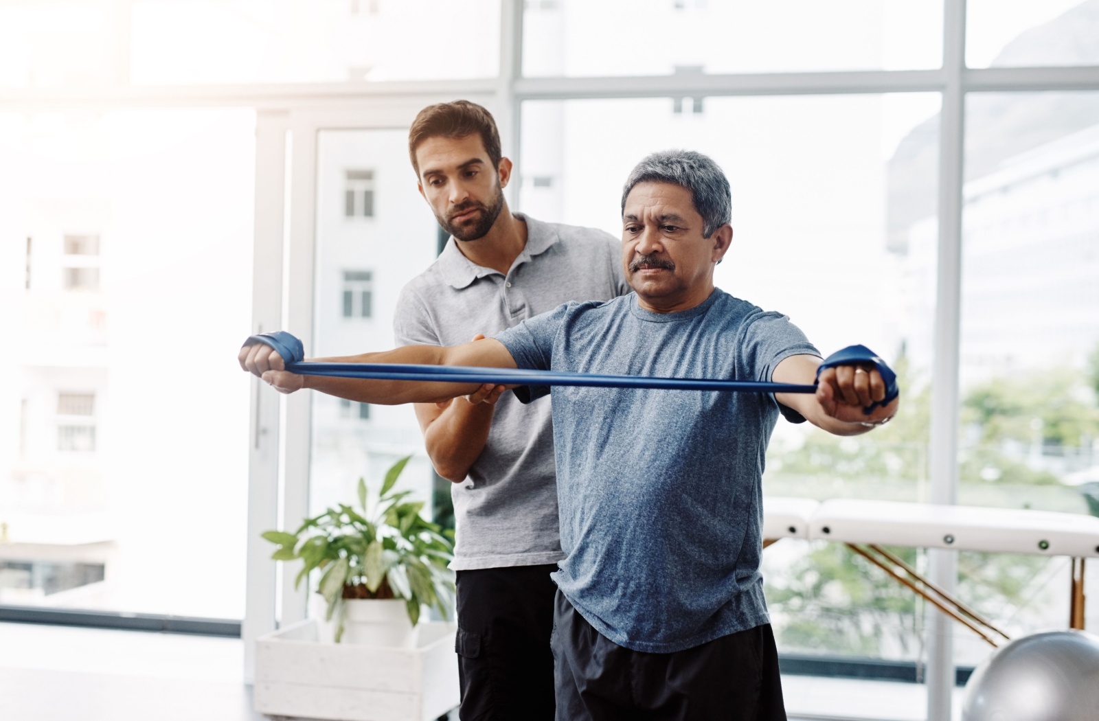 A man wearing loose, comfortable fitting closes to a physiotherapy session